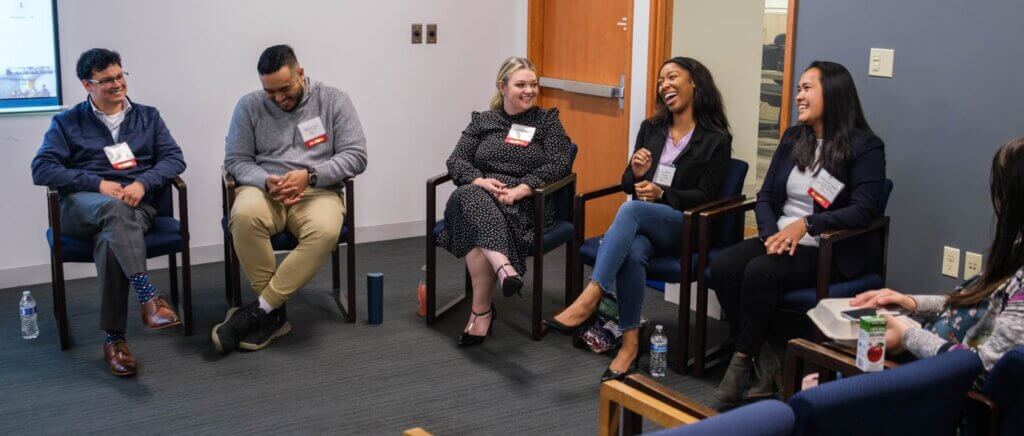 Alumni panelists smiling and laughing