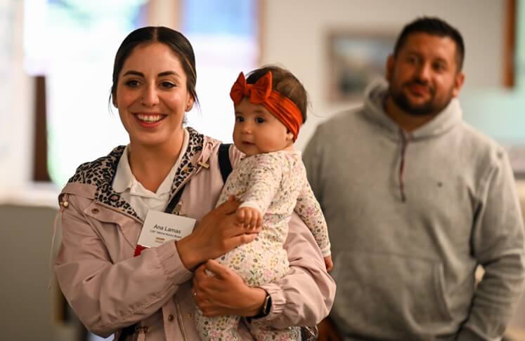 Conference attendee holding a baby
