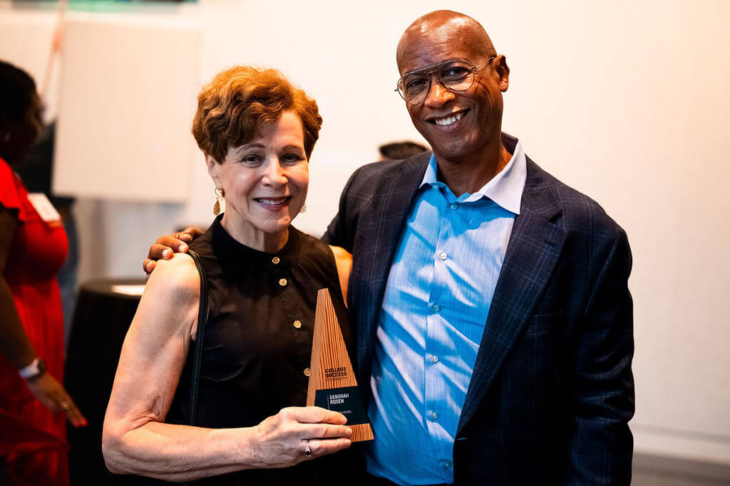 James Dorsey stands with Deborah Rosen, who holds a trophy
