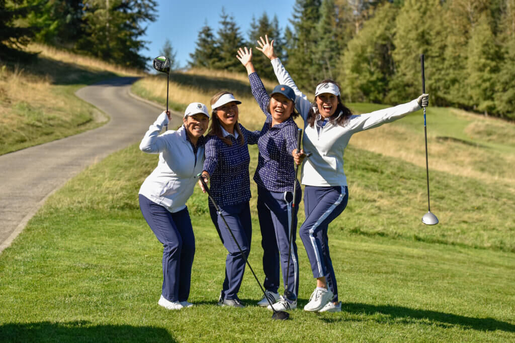 Four golfers celebrating on the course