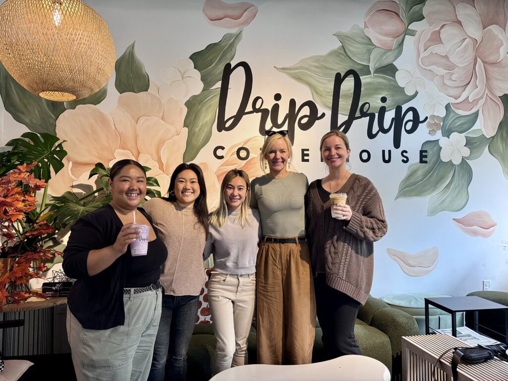 CSF alum Lan Bun stands in her coffeehouse with CSF staff